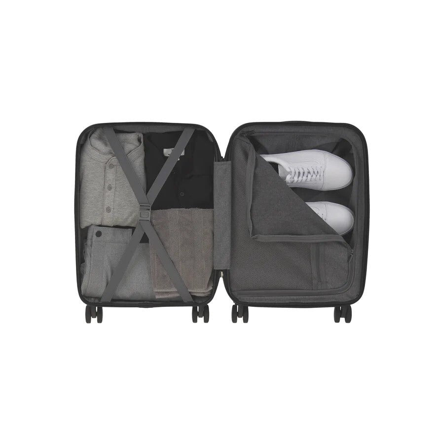 Interior compartments of Bugatti Paros luggage. Showing open storage with elastic straps and zippered compartment with shoes.