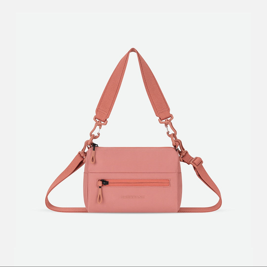 Pink handbag with a strap on a white background
