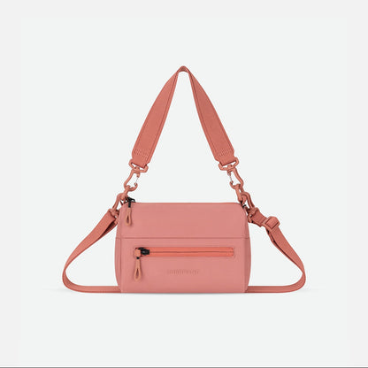 Pink handbag with a strap on a white background