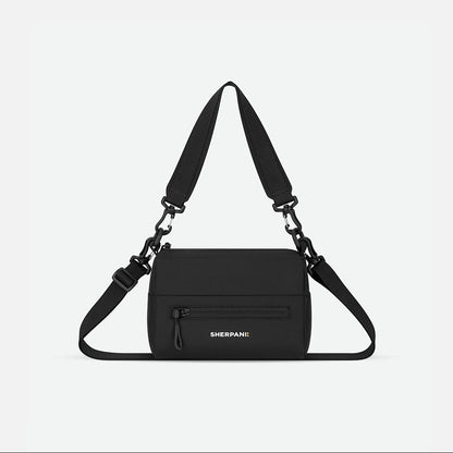Black shoulder bag with adjustable strap on a light gray background